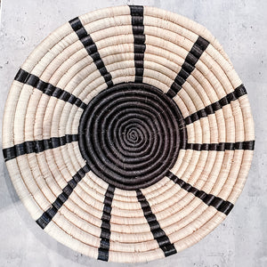 JustOne's natural basket with black stripes handwoven in Uganda