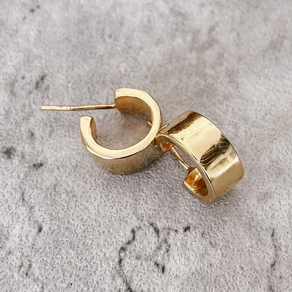 JustOne's brass gold plated small hoops that hug your ear, handcrafted in Kenya