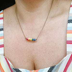 JustOne's thin necklace with five beads to make a rainbow handmade in Uganda