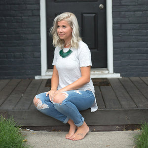 JustOne's necklace with long green paper beads dangling off, handcrafted in Uganda