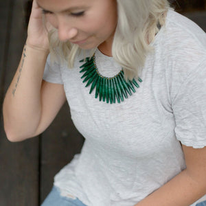 JustOne's necklace with long green paper beads dangling off, handcrafted in Uganda