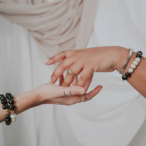 JustOne's bracelet with black and white beads made from ethically sourced bone and brass rings mixed in, handmade in Kenya