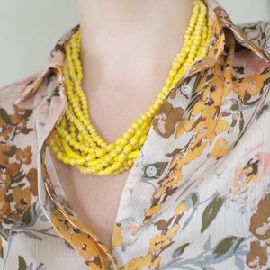 JustOne's chunky yellow necklace with seven strands of paper beads to create the one necklace, handmade in Uganda