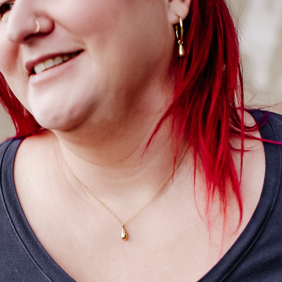 JustOne's brass necklace with teardrop charm, handcrafted in Kenya