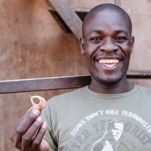 JustOne's dangling wooden earrings in the shape of a teardrop around 2 inches long, handcrafted in Kenya