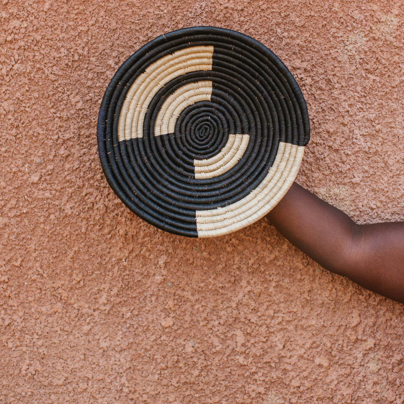 JustOne's black and neutral handwoven hanging basket from Uganda