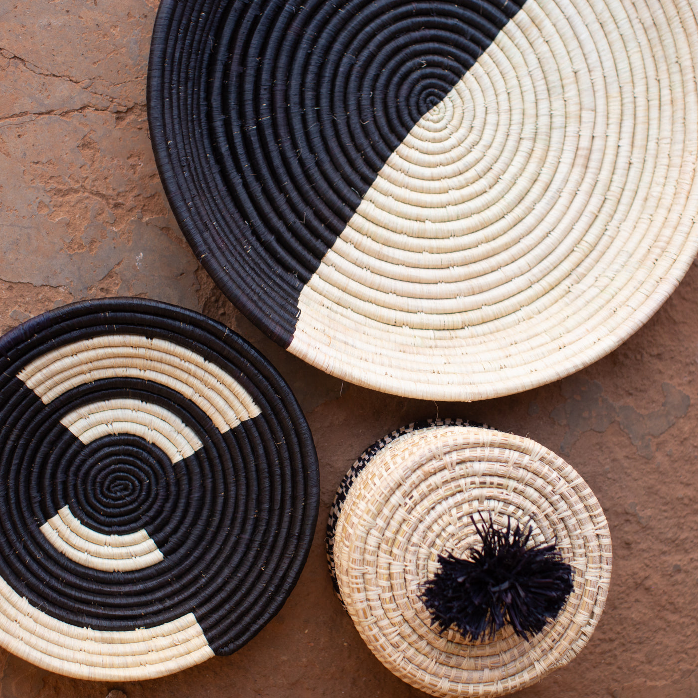 JustOne's black and neutral handwoven hanging basket from Uganda