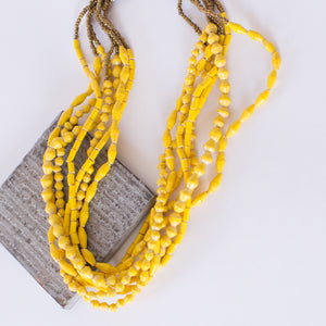 JustOne's chunky yellow necklace with seven strands of paper beads to create the one necklace, handmade in Uganda