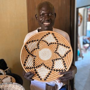 JustOne's yellow, tan, and black star design wall basket handwoven in Uganda