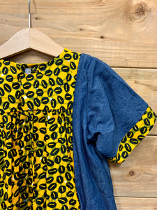 JustOne's small blue dress with design around the collar and cuffs of the sleeves, hand-sewn in Uganda