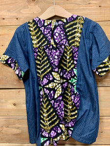 JustOne's small blue dress with design around the collar and cuffs of the sleeves, hand-sewn in Uganda