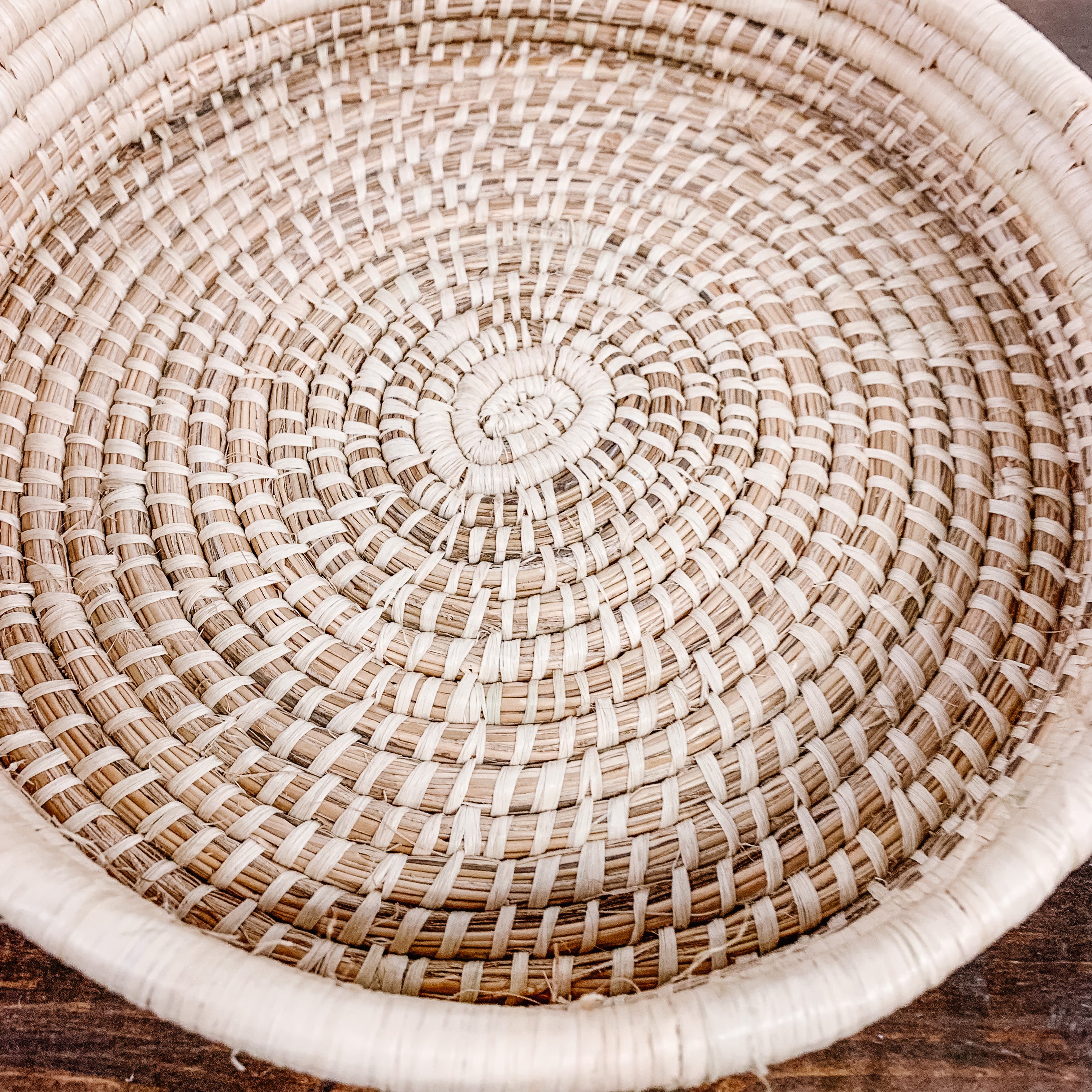 JustOne's tan medium, shallow basket, handwoven in Uganda