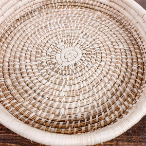 JustOne's tan medium, shallow basket, handwoven in Uganda
