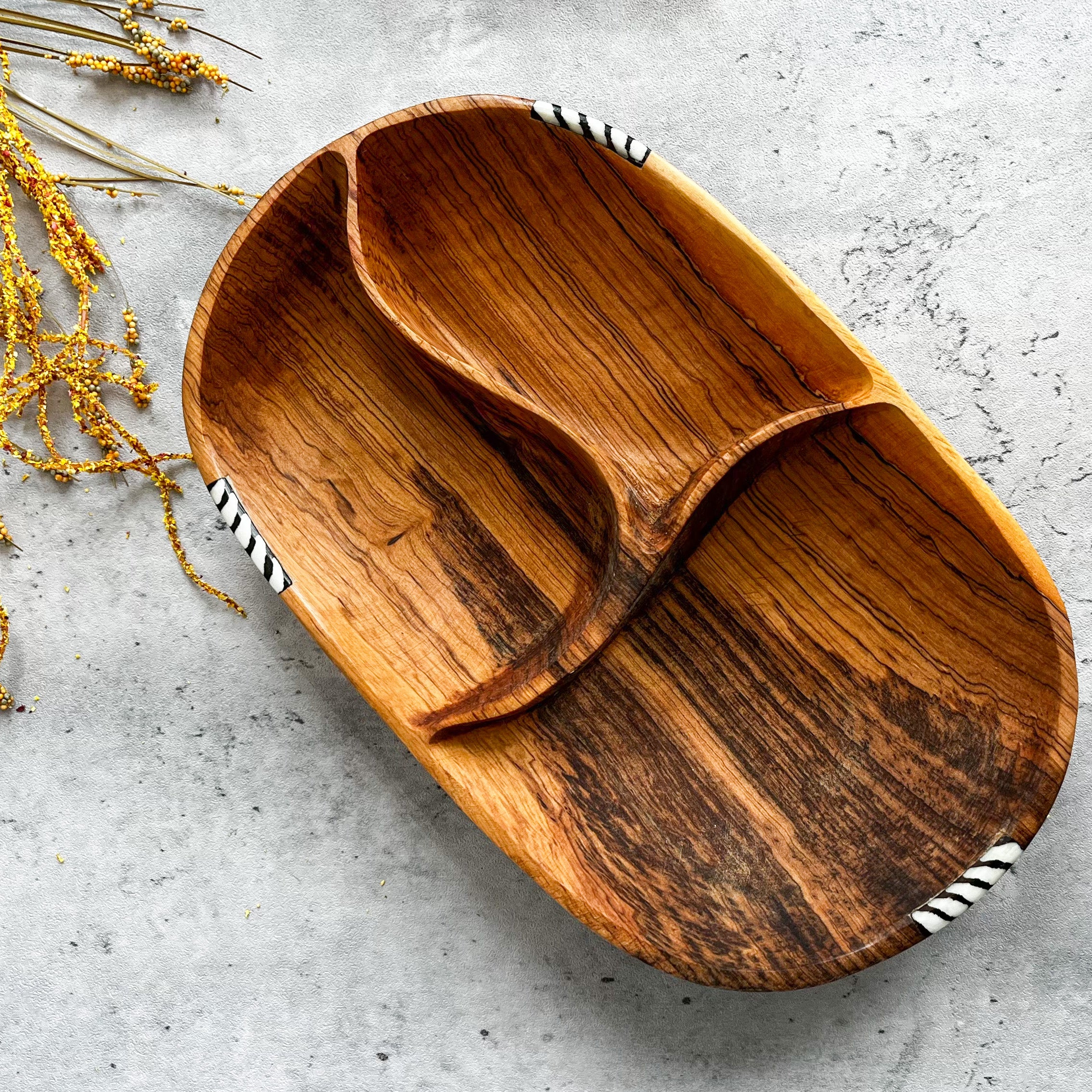 JustOne's oval wooden bowl with pieces of wood in the middle to create three sections, handmade in Kenya