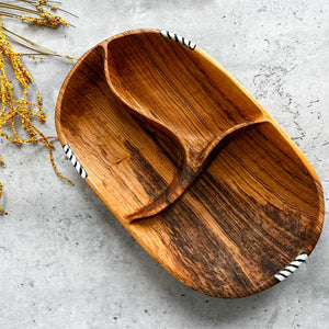 JustOne's oval wooden bowl with pieces of wood in the middle to create three sections, handmade in Kenya