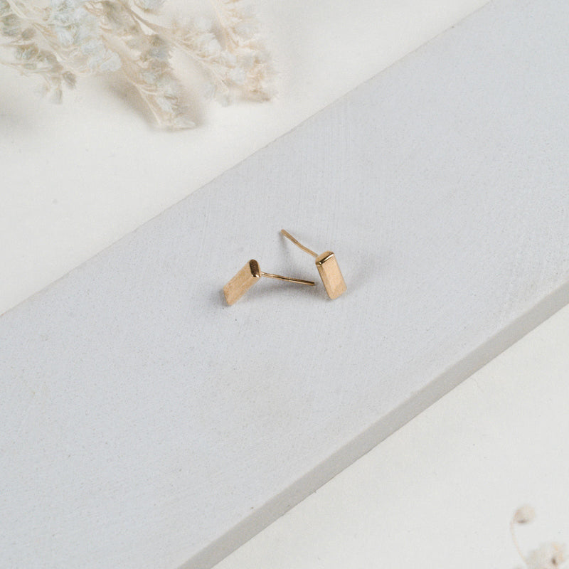 JustOne's small, brass, bar studs made ethically from recycled materials in Kenya