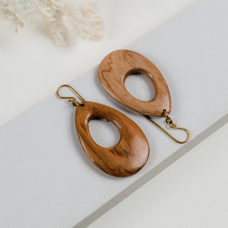 JustOne's dangling wooden earrings in the shape of a teardrop around 2 inches long, handcrafted in Kenya